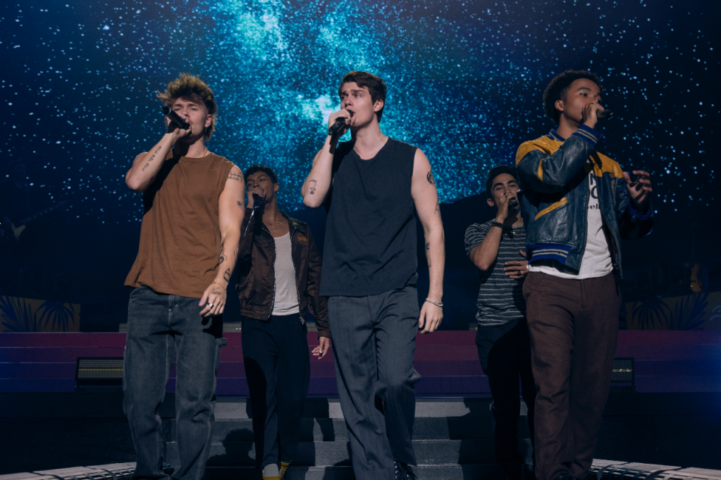 August Moon performing on stage, the One Direction fictional boyband on The Idea of You